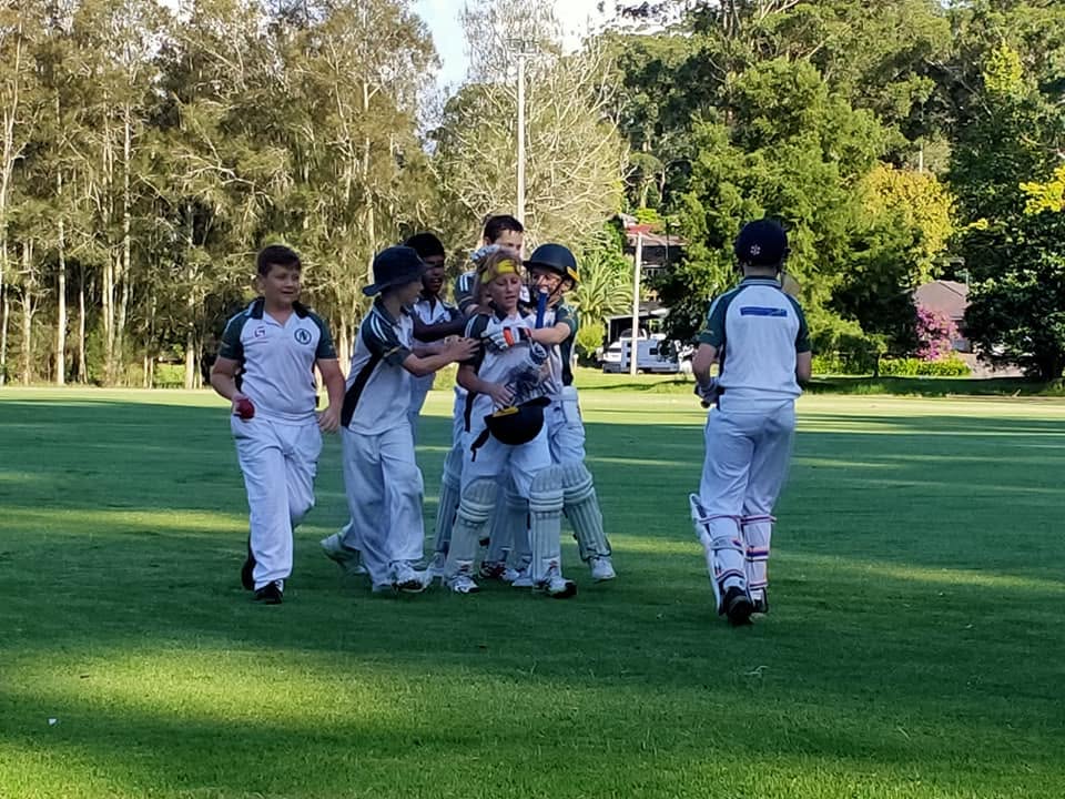 Juniors celebrating a wicket out on the field
