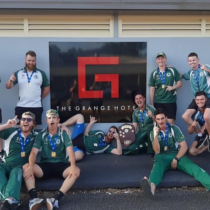 Men's team celebrating with the shield outside The Grange Hotel