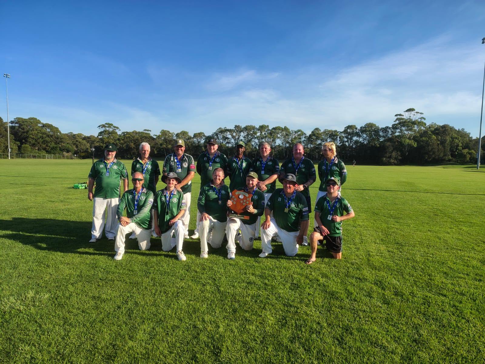 Veterans team on the field with their shield and medals