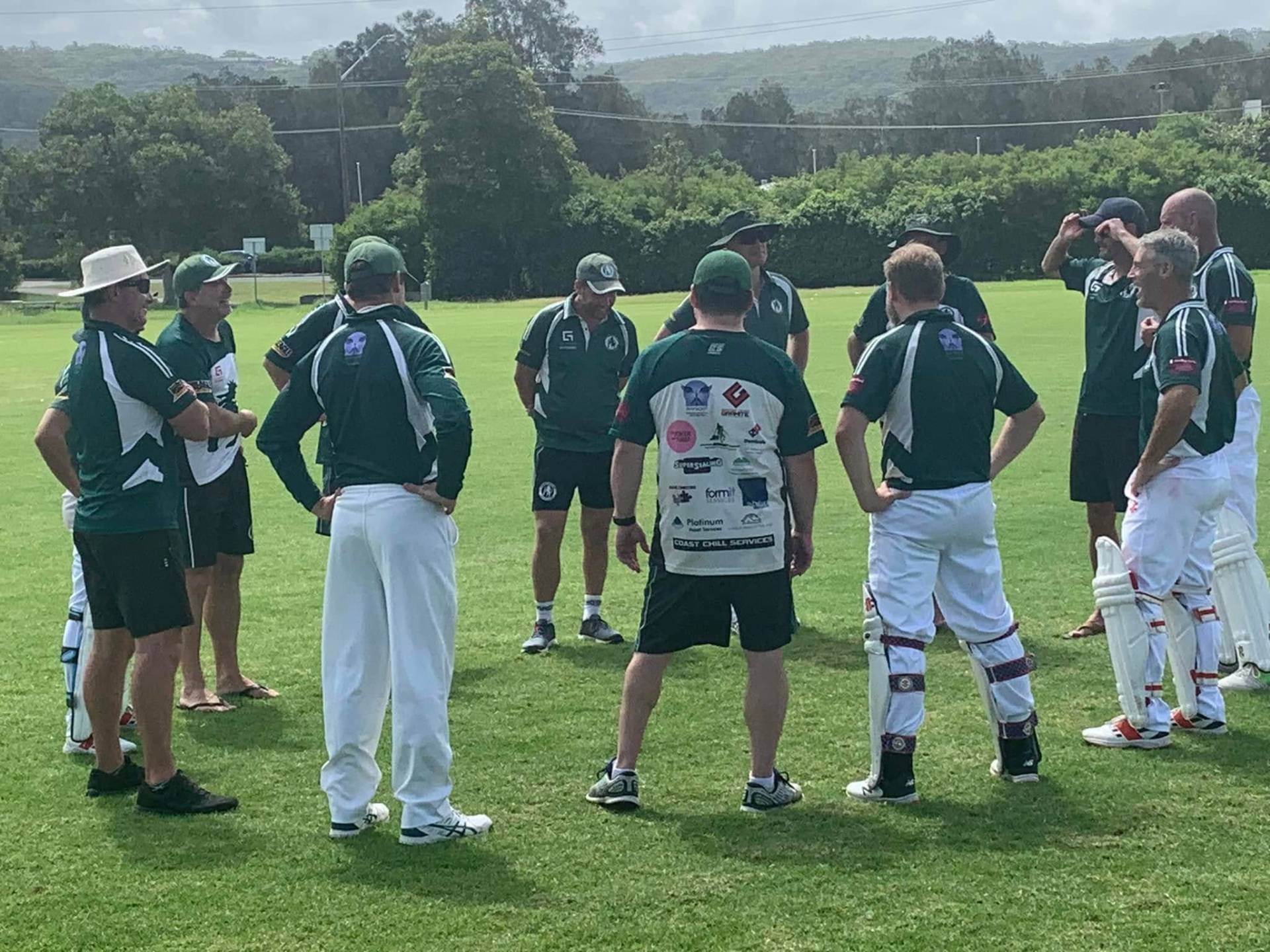 Men's team in a pre-match huddle on the field