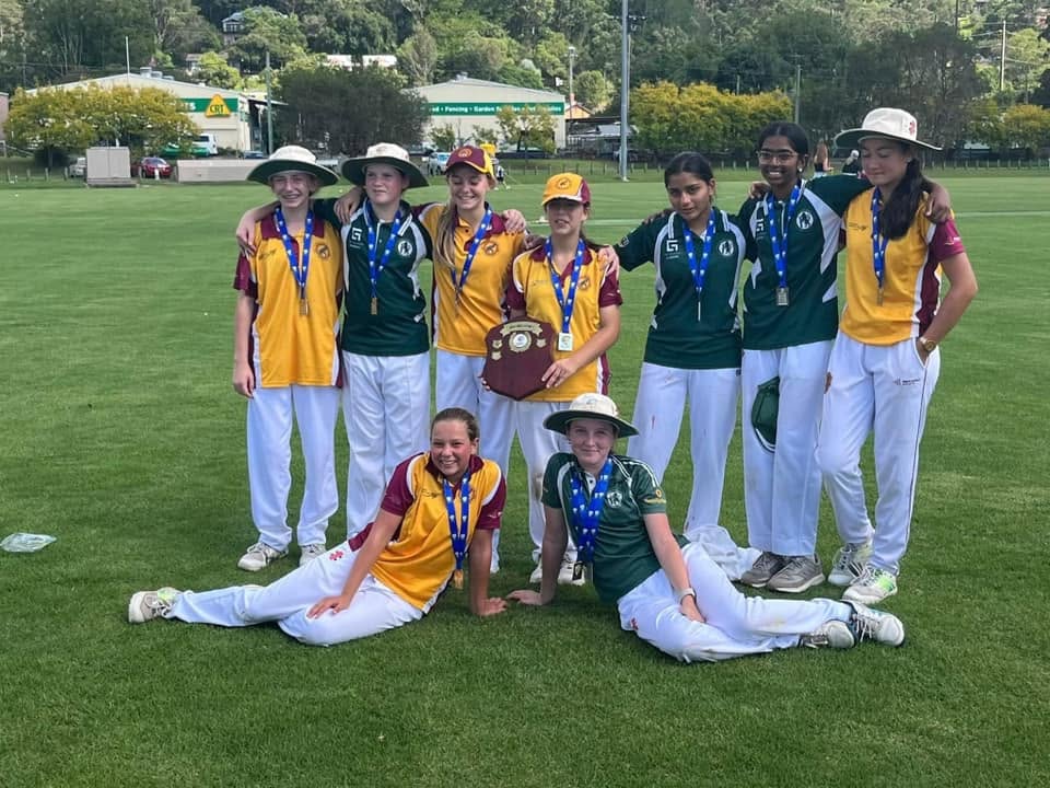 Junior girls team celebrating a shield win together