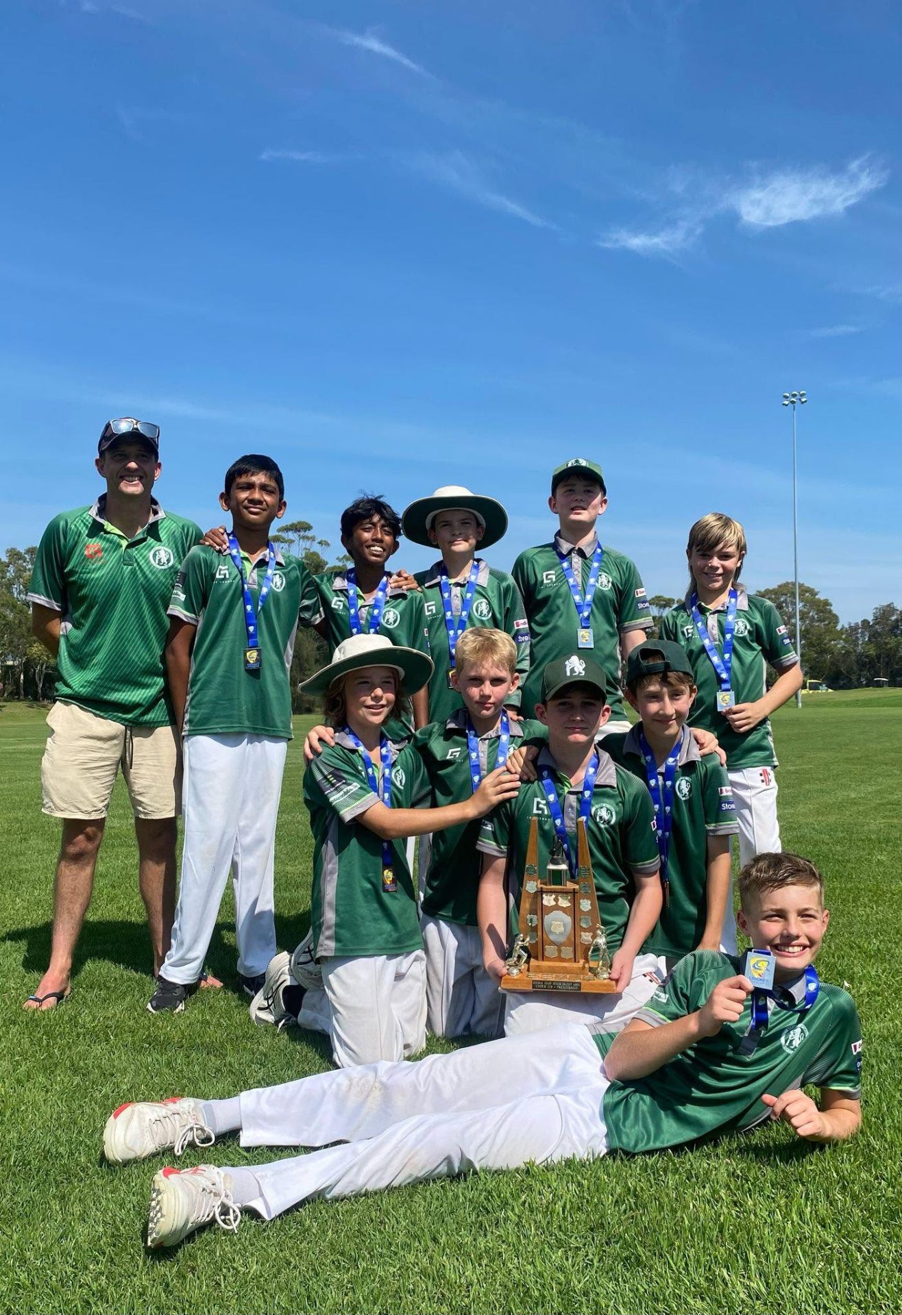 Under-12 boys celebrating a championship trophy