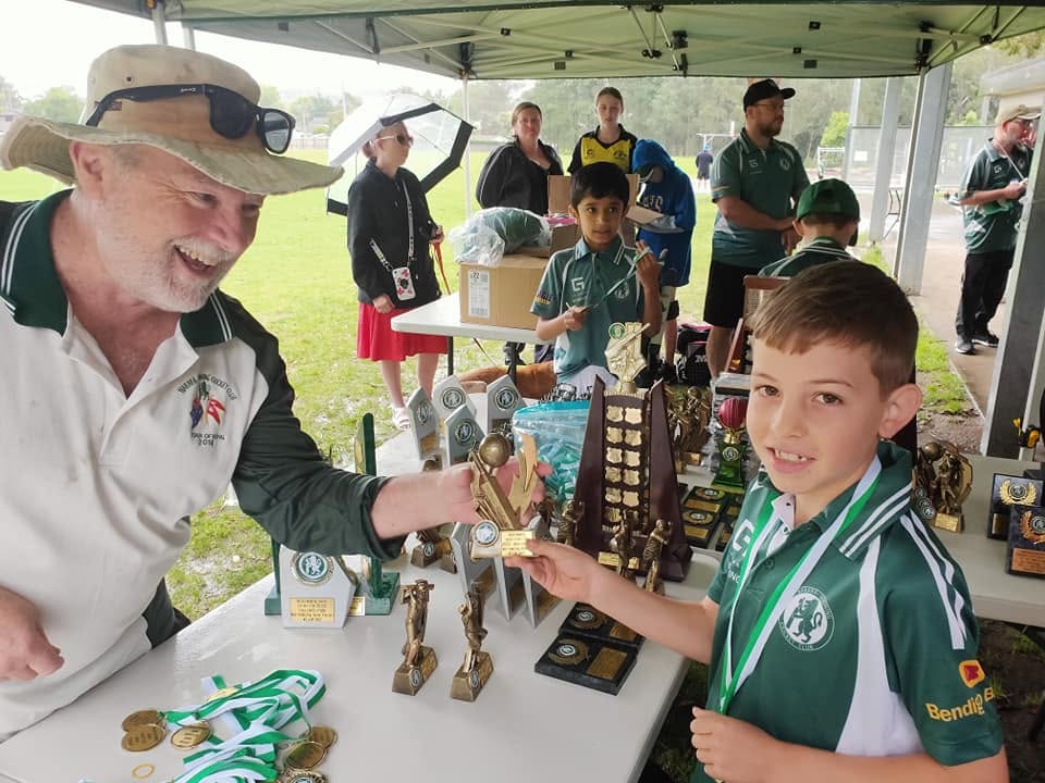 Junior player receiving trophies and medals on presentation day