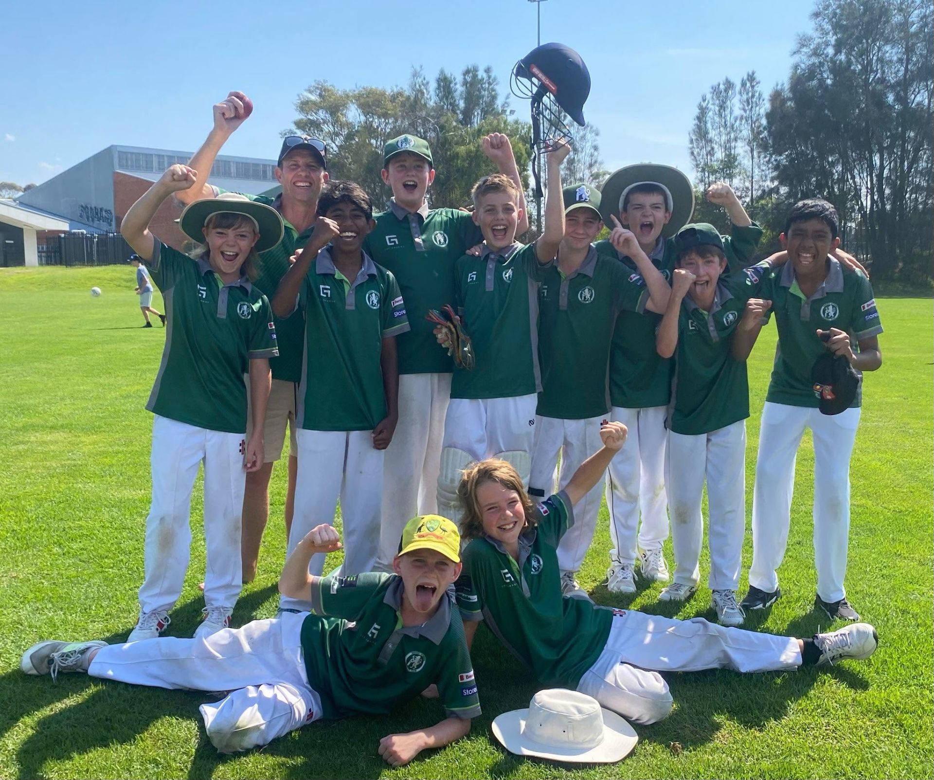 Junior team throwing helmets and cheering after a win